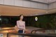 A woman standing in front of an escalator in a building.