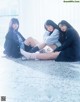 A group of young women sitting on the floor.